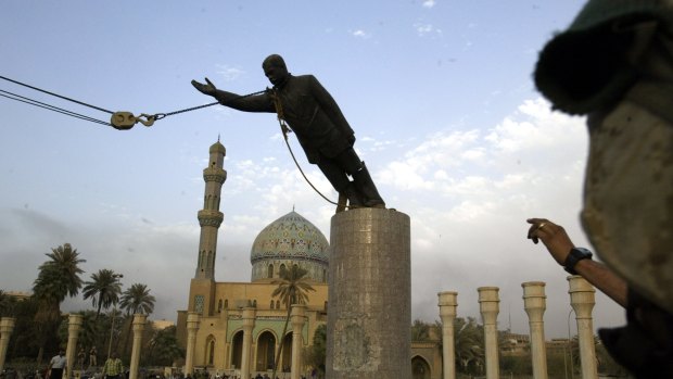 The statue of Saddam Hussein being toppled in Firdaus Square, downtown Bagdhad in 2003. The sledgehammer damage is visible on the base.