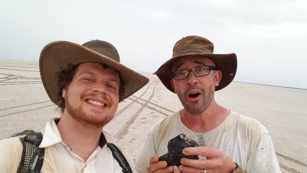 PhD student Robert Howie and Professor Phil Bland after digging the meteorite out of the ground. 
