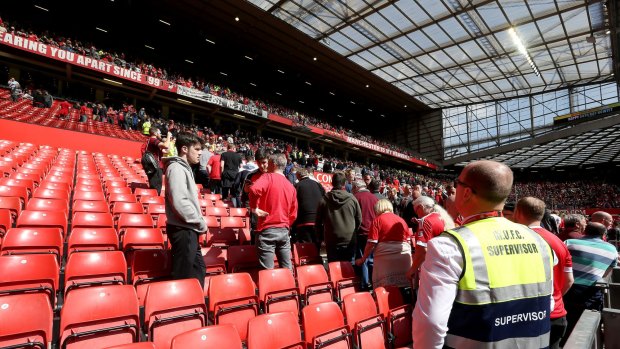 Fans leave Old Trafford after a suspect package was found at the ground.