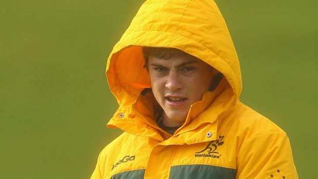 Wrapped up  ... James O'Connor keeps warm as he prepares for the Springboks in wet and windy Porirua.