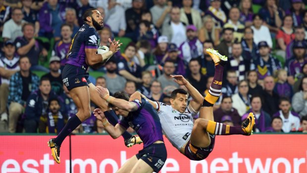 Josh Addo-Carr (left) and Curtis Scott of the Storm and Darius Boyd of the Broncos contest during the first NRL preliminary final.