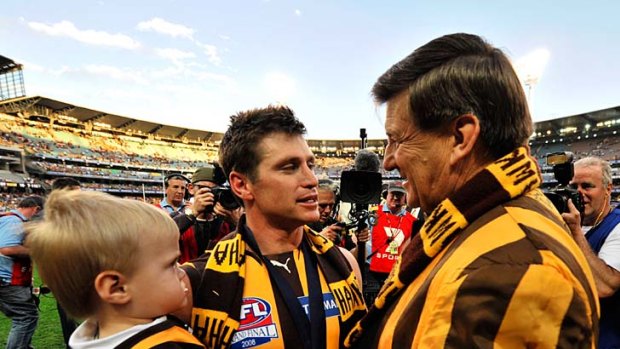 Colourful: Hawthorn president Jeff Kennett,  in his reversible brown-and-gold jacket, with Shane Crawford after the grand final in 2008.