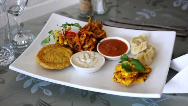 Himalaya's platter for two, with dumplings, chargrilled chicken, vegetable fritters, lentil patties  and radish salad  served with chutney and yoghurt.
