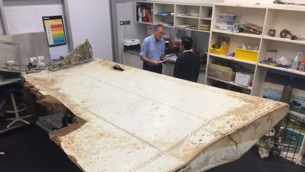 Malaysian and Australian investigators examine the piece of aircraft debris found on Pemba Island off the coast of Tanzania