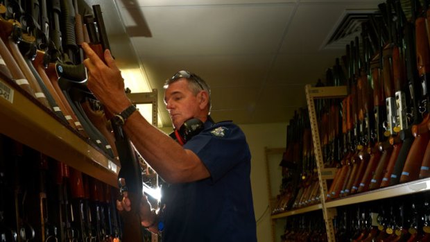Firepower: Sergeant Mark Chandler chooses a test weapon from the gun library at the Forensic Services Department.