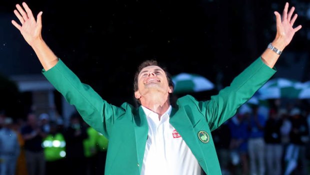 Adam Scott celebrates with his 2013 US Masters green jacket.