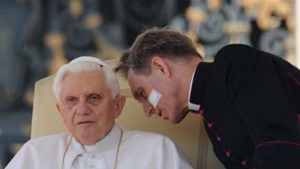 Call for healing ... the Pope  takes counsel from his personal secretary, Reverend Monsignor Georg Gaenswein, during his address to pilgrims in St Peter’s Square this week.