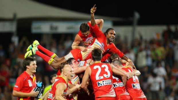 The Suns celebrate Karmichael Hunt's match-winning goal against Richmond.