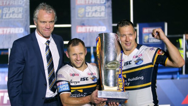 Leeds coach Brian McDermott, Rob Burrow and Danny McGuire celebrate with the trophy after the Super League grand final.