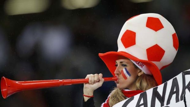Drone goal: A fan joins the vuvuzela horn symphony at the World Cup.