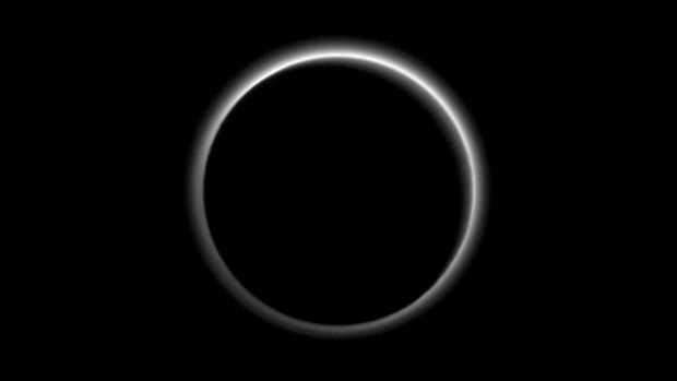 The atmosphere of Pluto backlit by the sun when the New Horizons spacecraft was about 2 million kilometres away. The image, delivered to Earth on July 23, is displayed with north at the top of the frame.