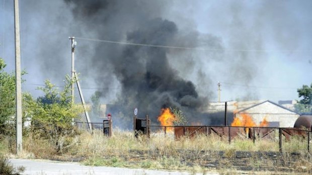 Black smoke billows over fire after shelling on the outskirts of the small southern Ukrainian city of Novoazovsk in the Donetsk region.