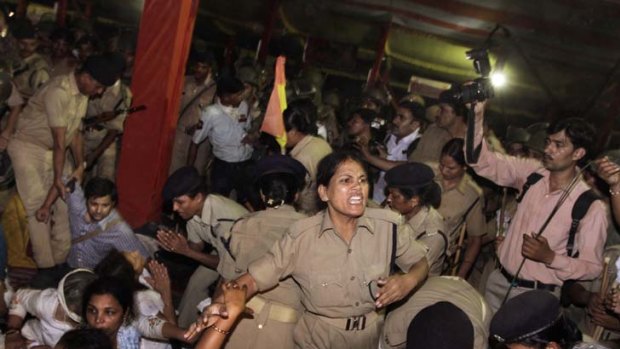 Indian police officers remove supporters from a hunger strike led by Baba Ramdev.