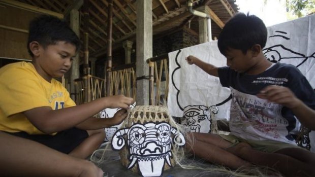 Children from a remote Indonesian community create puppets during a visit by members of Melbourne's Polyglot Theatre.