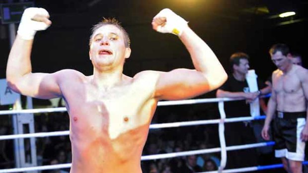 Russian Nikolay Sazhin celebrates his chess boxing victory over Germany's Frank Stoldt.