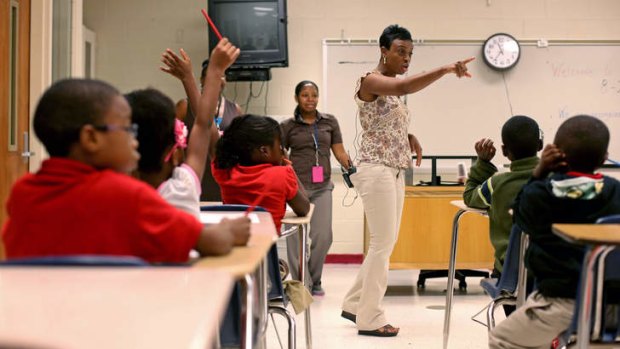 Ronald E. McNair Discovery Learning Academy first-grade teacher Sherlita Bickham directs her class on the day after the shooting incident.