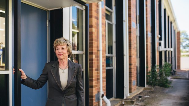 Narrabundah College principal Kerrie Grundy with one of the buildings set to be demolished due to asbestos contamination.