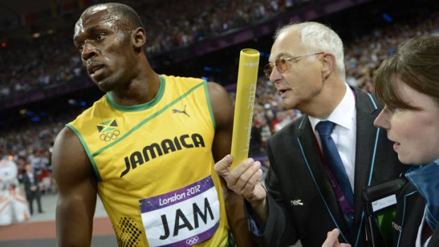 It's mine ... judges argue with Jamaica's Usain Bolt for the baton.