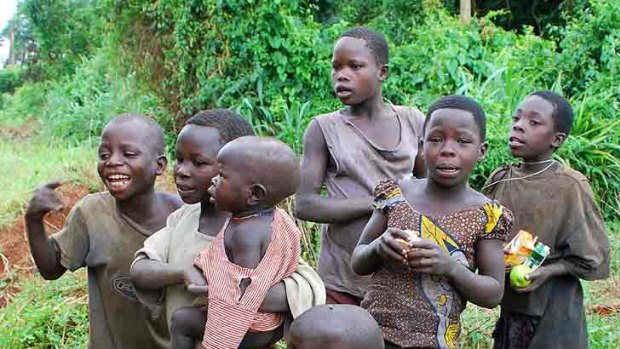 Children greet mzungu (foreigners) by the road in Uganda.