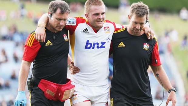 Sam Cane is helped off the field.