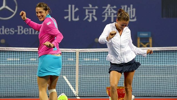 Andrea Petkovic and Agnieszka Radwanska do a dance on court after the China Open final, won by Radwanska, last October.