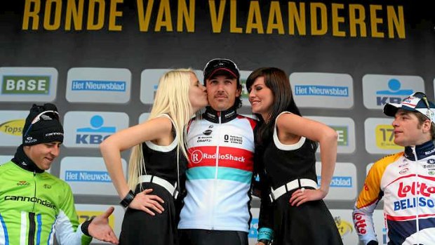 Caught in the act ... Peter Sagan on the podum as race winner Fabian Cancellara is kissed.