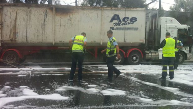Emergency services mop up after a truck fire on the Monash Freeway.