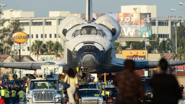 Last resting place ... the space shuttle Endeavour is transported through the streets of Los Angeles on the way to its permanent museum home.
