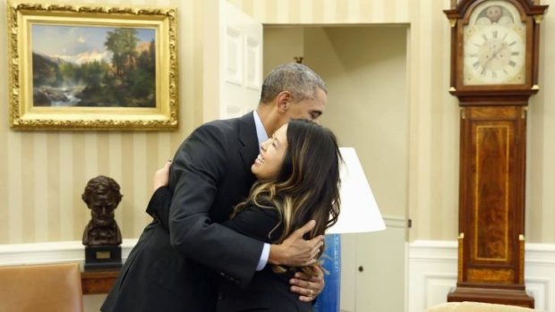 President Barack Obama hugs nurse Nina Pham, who was declared free of the Ebola virus after contracting the disease over a week ago.