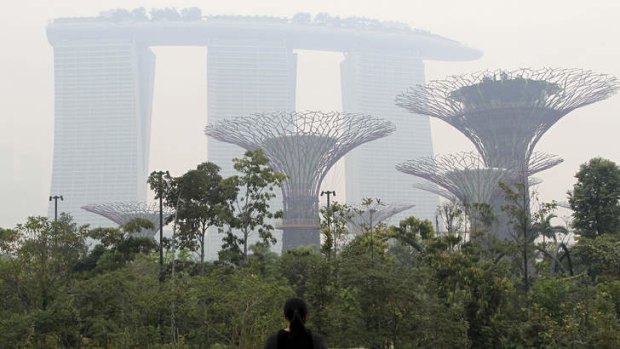 Fuzzy: The Marina Bay Sands hotel and Supertrees at Gardens by the Bay are covered in haze in Singapore.