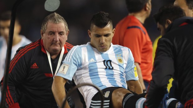 Sidelined: Argentina's Sergio Aguero is carried off the field after an injury during the World Cup qualifier against Ecuador.