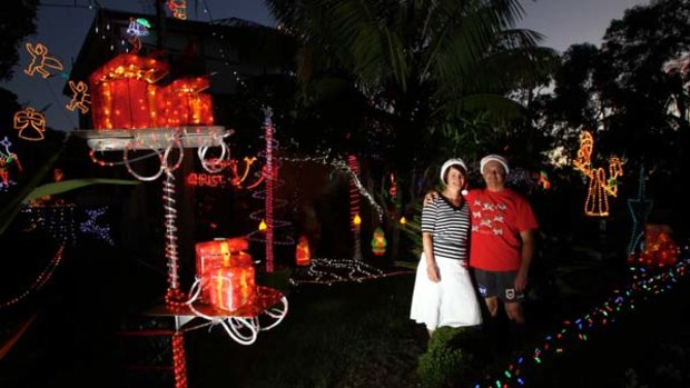 Twinkle, twinkle ... Greg and Fiona Young, of Caringbah, are lit up by the yuletide LED extravaganza.