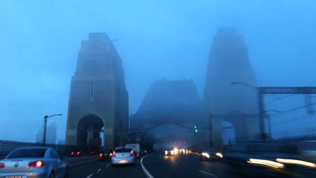 Fog blankets the Harbour Bridge this morning.
