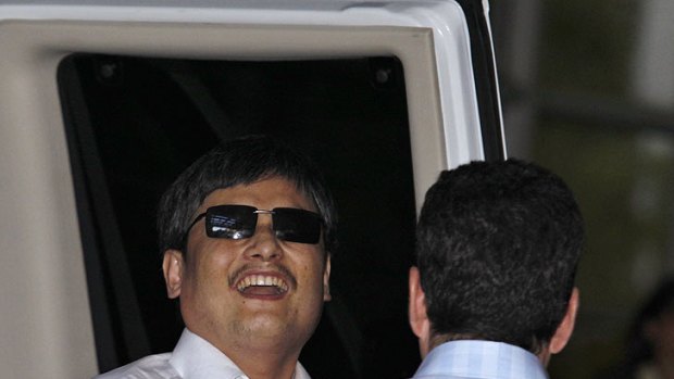 Blind Chinese dissident Chen Guangcheng  smiles  as he arrives in New York.