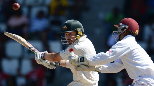Australian batsman Ed Cowan slips a shot past West Indies Carlton Baugh.