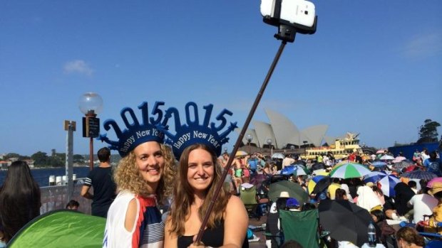 Tourists making use of a selfie stick last New Year's Eve in Sydney.