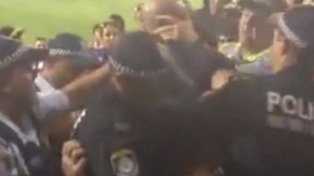 A screen grab of a tussle between police and fans at Hunter Stadium.