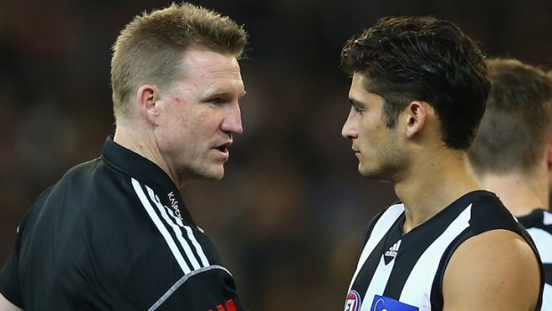 Reflecting: Sharrod Wellingham (right) talks to Pies coach Nathan Buckley.