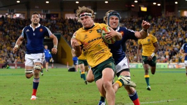 Wallabies forward Michael Hooper breaks away from the French to score on Saturday night in Brisbane.