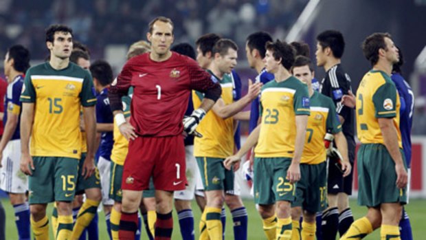 Australia's goalkeeper Mark Schwarzer (number one) and teammates react after losing the 2011 Asian Cup final to Japan.