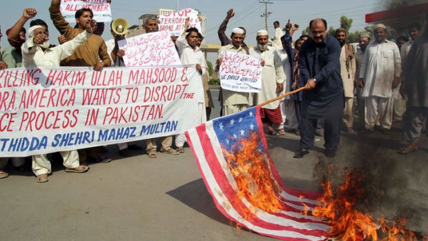 Pakistani protesters burn a US flag in protest at the killing of  Taliban leader Hakimullah Mehsud in a US drone attack.