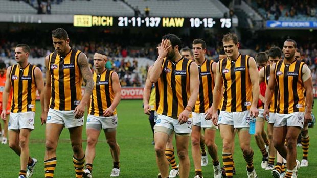 Unhappy Hawks: The defeated Hawthorn players  trudge from the MCG yesterday after going down to Richmond.