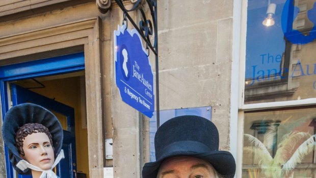 A Museum Greeter in period costume outside the entrance to the Jane Austen Centre in Bath. 
