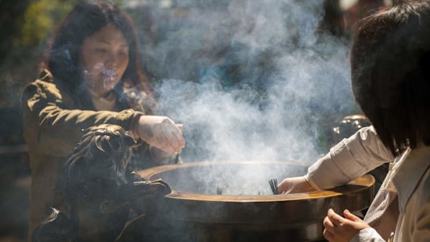 Lighting incense at Kumano Nachi Taisha.