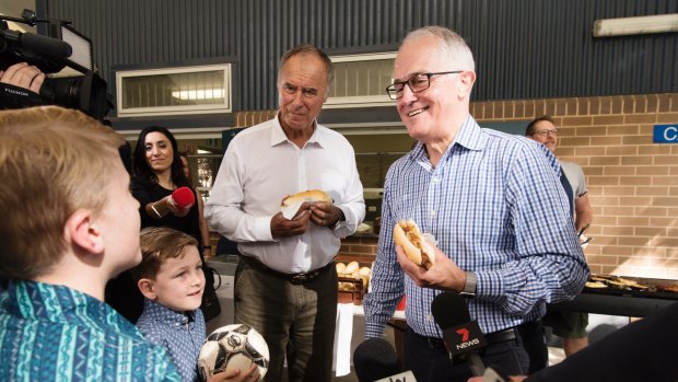 Prime Minister Malcolm Turnbull with Liberal candidate John Alexander at eat some hot dogs at the Gladesville Public School polling booth.