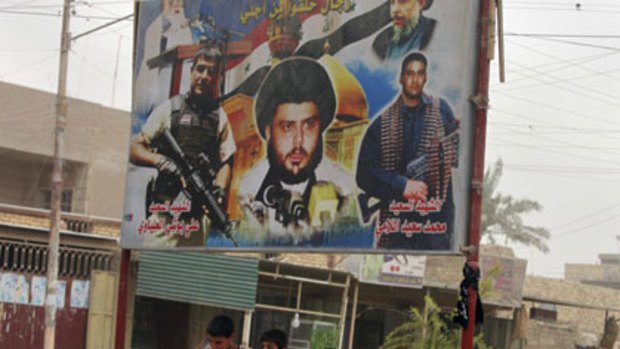 Children walk past a poster of anti-U.S. cleric Muqtada al-Sadr in a Shiite stronghold of Baghdad.