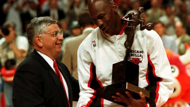 NBA commissioner David Stern congratulates Chicago Bulls guard Michael Jordan as he is presented with the 1996 NBA Most Valuable Player award.