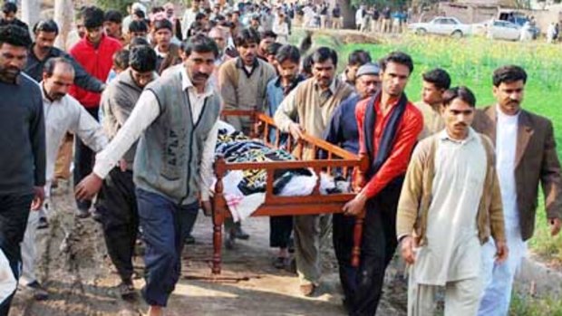 Pakistani villagers carry the dead body of Shumaila Kanwal, who committed suicide after her husband ws shot dead.