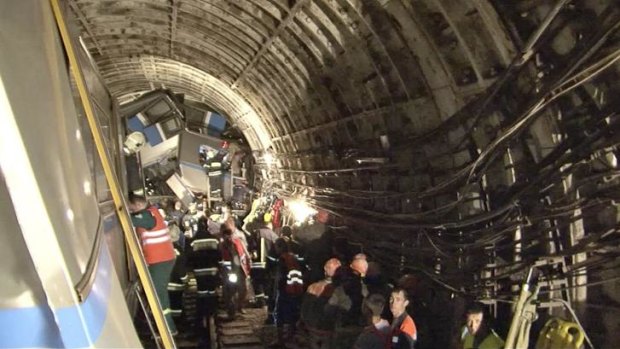Rescue teams work inside the tunnel where the train derailed.