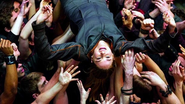 Shailene Woodley crowd-surfing in <em>Divergent</em>.